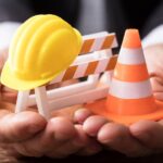 Close-up Of Barricade With Traffic Cone And Hard Hat